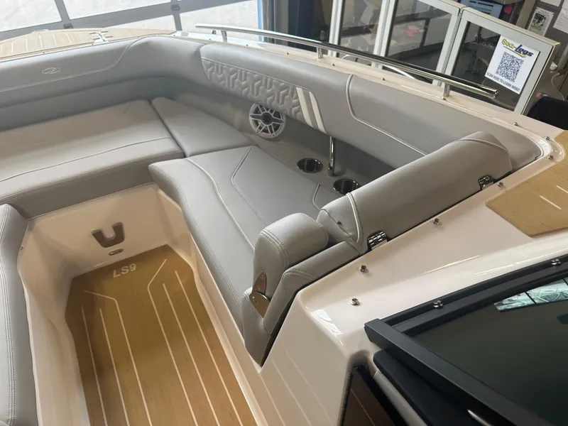 Slide: The Image of 2026 Regal LS9 boat interior with gray seating and cup holders. - 17