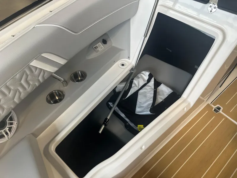 Slide: The Image of 2026 Regal LS9 boat interior storage compartment with cup holders and speaker. - 21