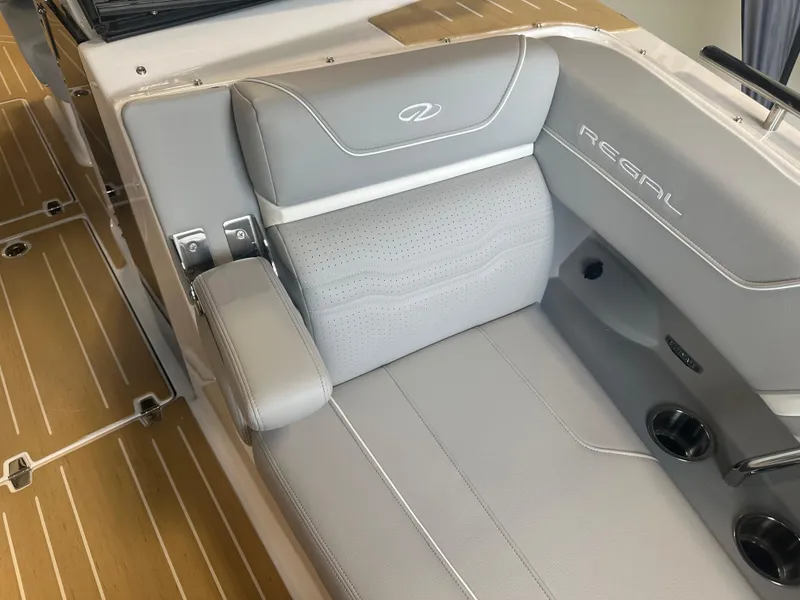 Slide: The Image of 2026 Regal LS9 boat interior with gray leather seating and cup holders. - 23