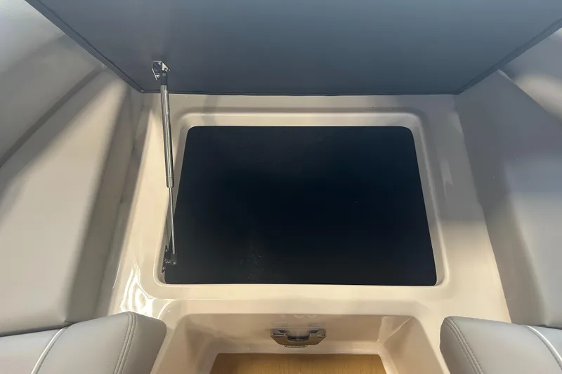 Slide: The Image of Open storage compartment in 2026 Regal LS9 boat interior. - 32