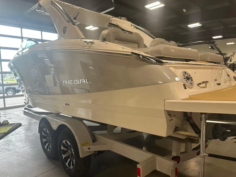 Slide: The Image of 2026 Regal LS9 boat on trailer in showroom, showcasing sleek design and modern features. - 4