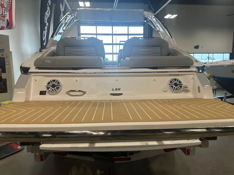 Slide: The Image of 2026 Regal LS9 boat interior with cushioned seating and modern design in showroom. - 5