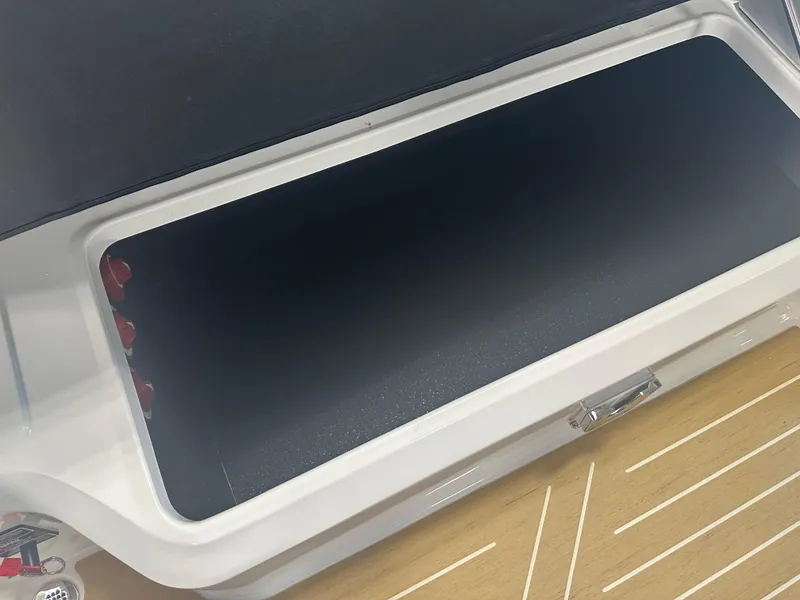 Slide: The Image of Open storage compartment in 2026 Regal LS9 boat, featuring sleek design and spacious interior. - 8
