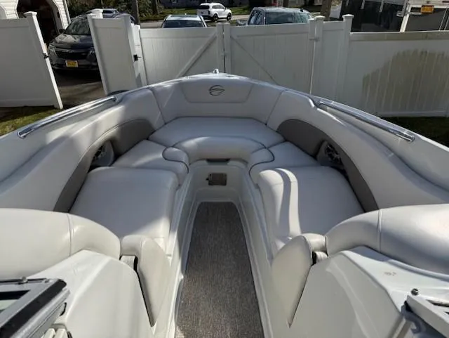 Slide: The Image of 2016 Crownline 270 SS boat interior with white seating and open deck layout. - 15
