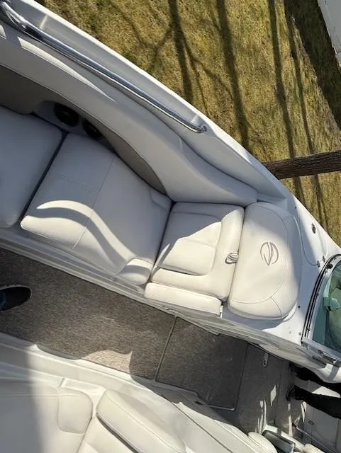 Slide: The Image of 2016 Crownline 270 SS boat interior with white seating and carpeted floor. - 16