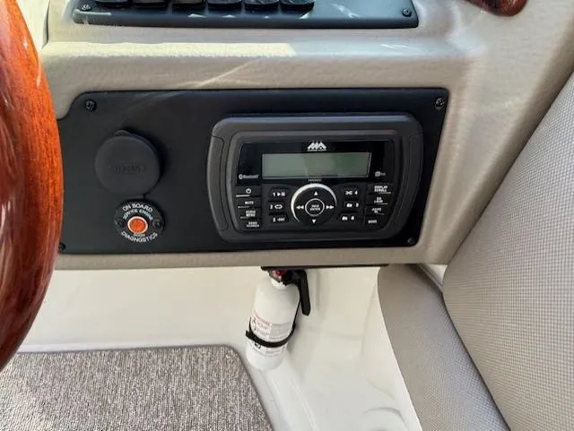 Slide: The Image of Control panel of 2016 Crownline 270 SS boat with stereo system and fire extinguisher. - 21
