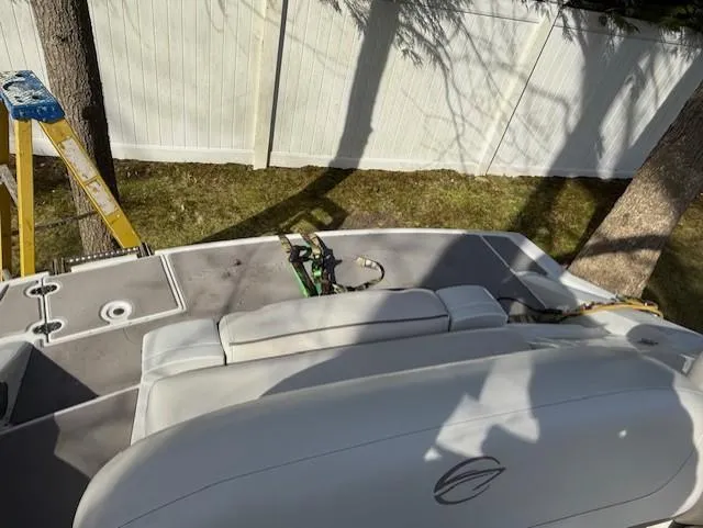 Slide: The Image of 2016 Crownline 270 SS boat interior with seating, ladder, and fence in background. - 23