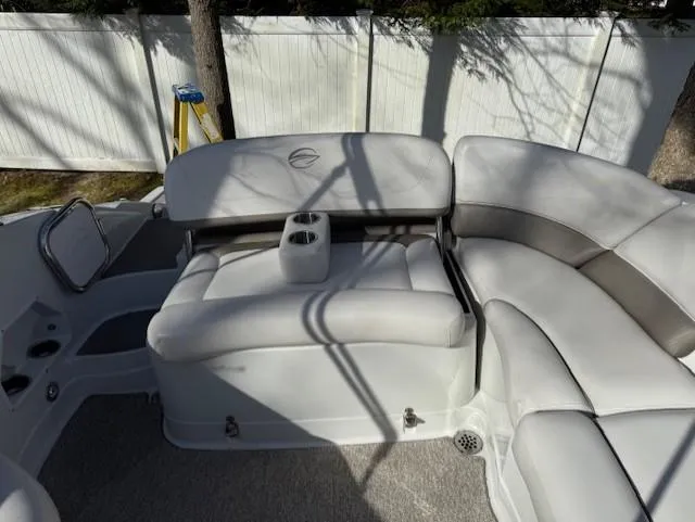 Slide: The Image of 2016 Crownline 270 SS boat interior with white cushioned seating and cup holders. - 9