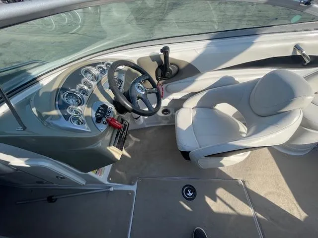 Slide: The Image of 2008 Crownline 230 LS boat interior with steering wheel and dashboard controls. - 10