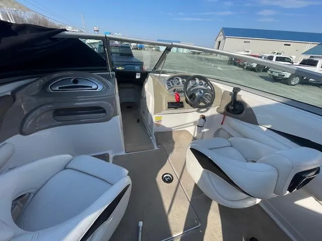 Slide: The Image of 2008 Crownline 230 LS boat interior with white seating and dashboard controls. - 11