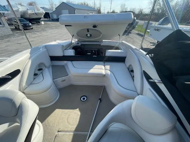 Slide: The Image of 2008 Crownline 230 LS boat interior with white seating and open storage compartment. - 13