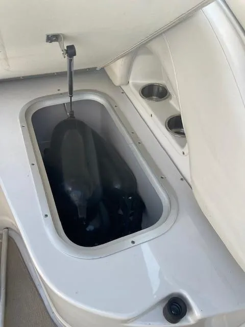 Slide: The Image of 2008 Crownline 230 LS boat storage compartment with cup holders. - 15