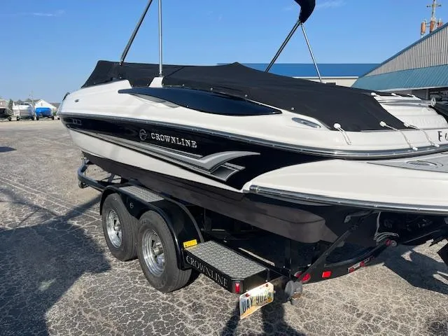 Slide: The Image of 2008 Crownline 230 LS boat on trailer, black and white design, parked outdoors. - 6