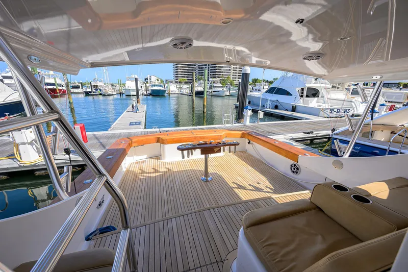 Slide: The Image of Luxurious 2006 Blackwell Custom Carolina yacht interior at marina, featuring spacious deck and seating. - 11