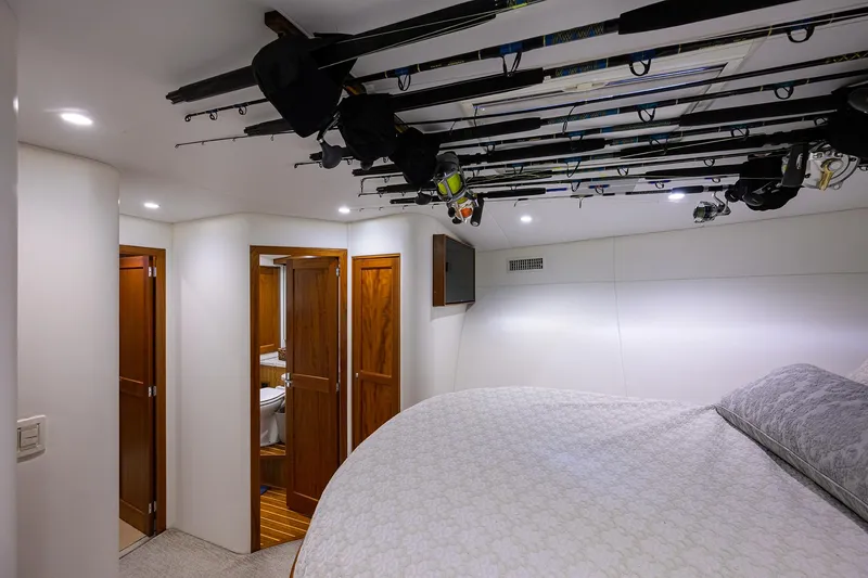 Slide: The Image of Luxurious 2006 Blackwell Custom Carolina yacht interior with fishing rods and elegant wood finishes. - 25