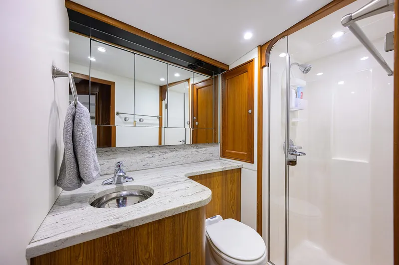 Slide: The Image of Luxurious bathroom in 2006 Blackwell Custom Carolina yacht with modern fixtures and wooden cabinetry. - 28