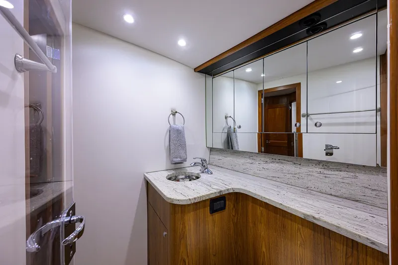 Slide: The Image of Luxurious bathroom in 2006 Blackwell Custom Carolina yacht with modern fixtures and wooden cabinetry. - 29