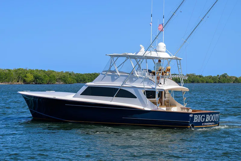 Slide: The Image of 2006 Blackwell Custom Carolina yacht on water, clear sky, lush green shoreline. - 37