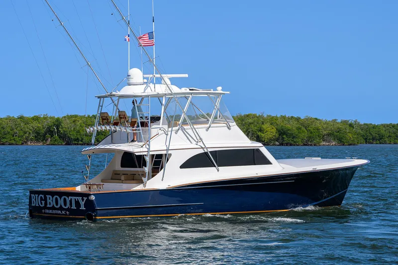 Slide: The Image of 2006 Blackwell Custom Carolina yacht on water, blue hull, white superstructure, American flag flying. - 38