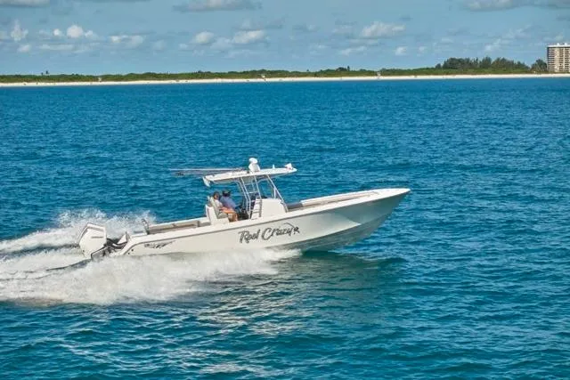 The Image of 2022 Bluewater 35 boat cruising on open water under a clear sky. - 0