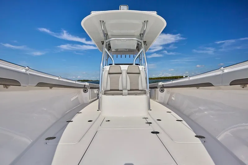 Slide: The Image of 2022 Bluewater 35 boat interior with sleek design and spacious seating under clear blue sky. - 12