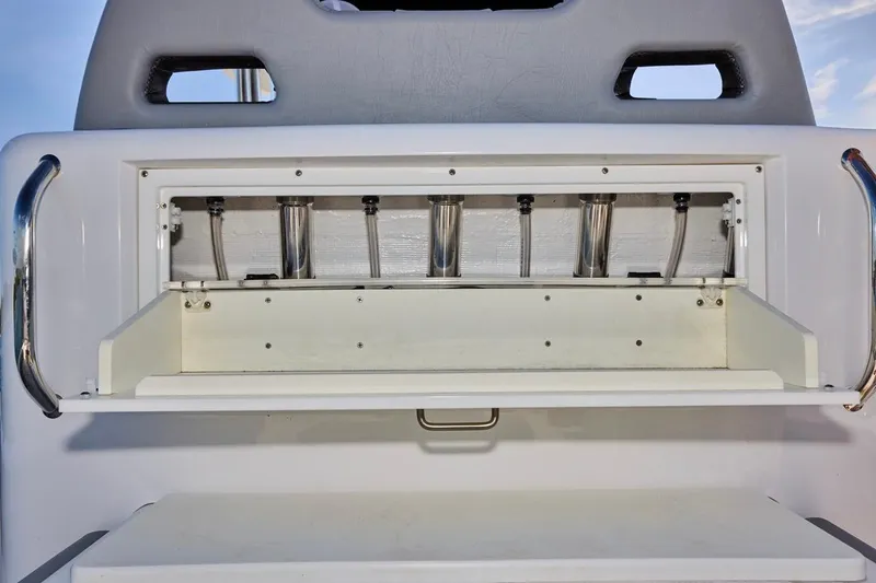 Slide: The Image of 2022 Bluewater 35 boat storage compartment with stainless steel rod holders. - 15