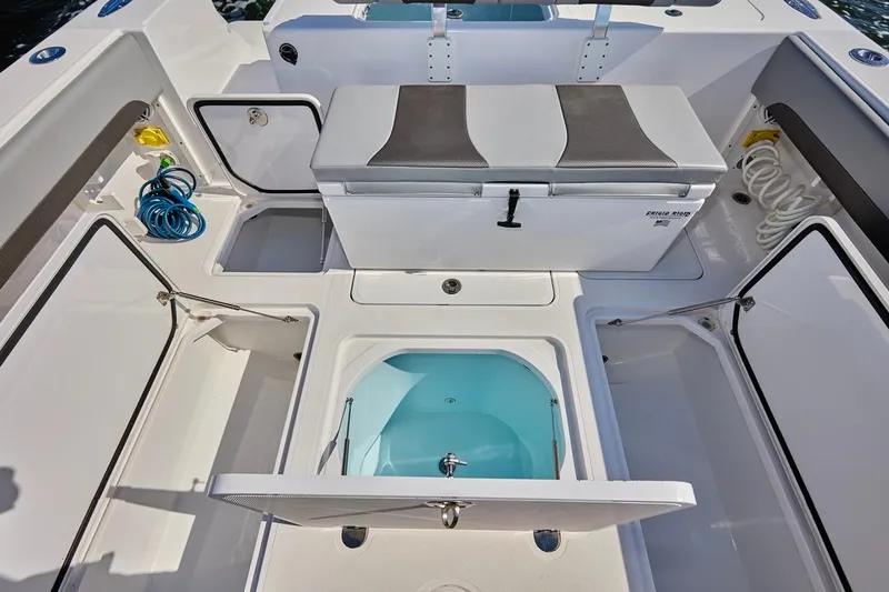 Slide: The Image of 2022 Bluewater 35 boat interior with storage compartments and seating. - 17
