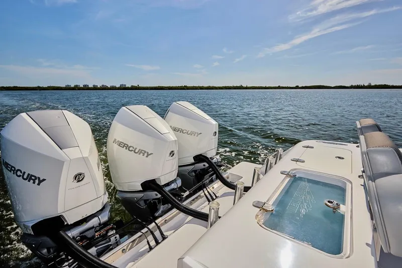 Slide: The Image of 2022 Bluewater 35 boat with triple Mercury outboard engines on open water. - 19