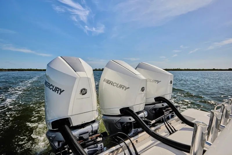 Slide: The Image of Triple Mercury outboard engines on a 2022 Bluewater 35 boat, cruising on open water. - 20