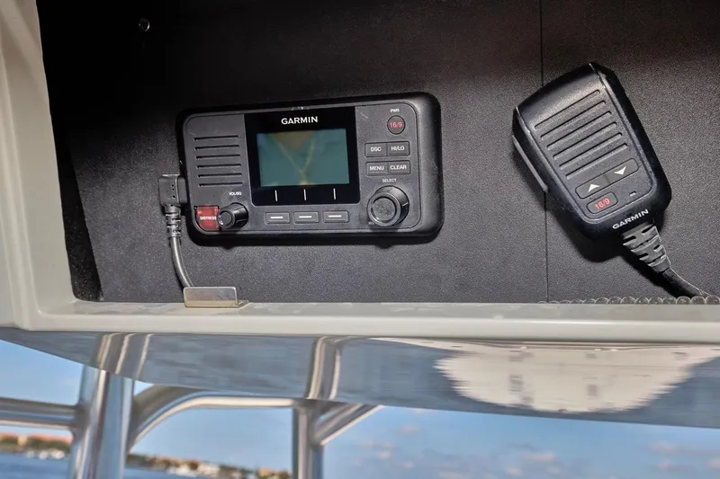 Slide: The Image of Garmin marine radio on 2022 Bluewater 35 boat, featuring a microphone and control panel. - 24