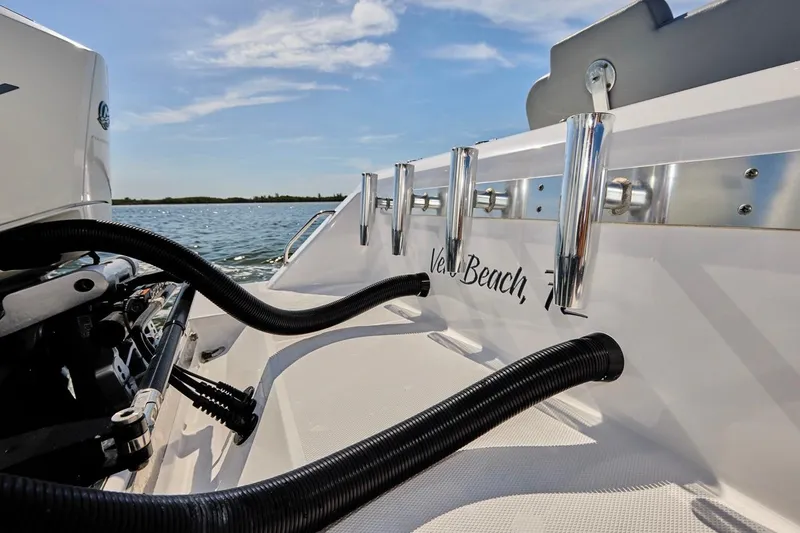 Slide: The Image of 2022 Bluewater 35 boat with rod holders and engine, on a sunny day at sea. - 25