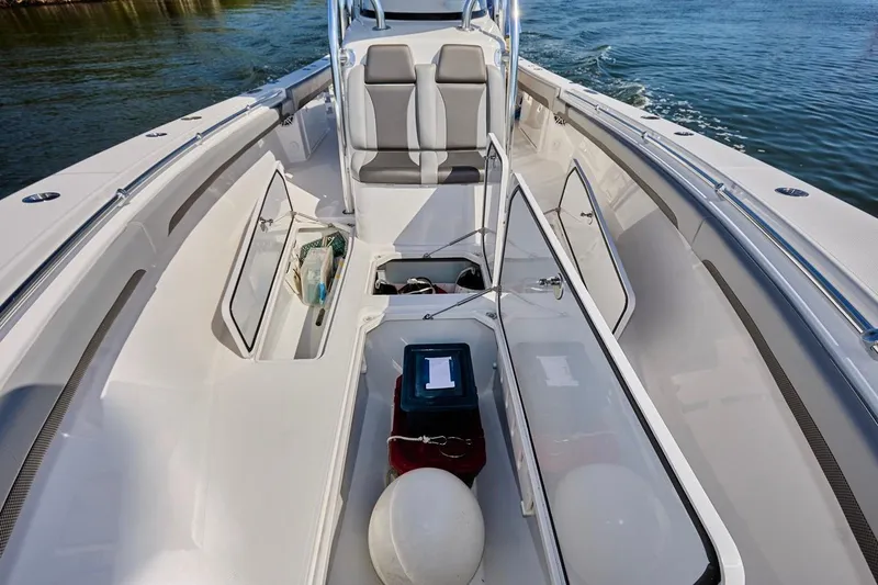 Slide: The Image of 2022 Bluewater 35 boat interior with open storage compartments on calm water. - 28