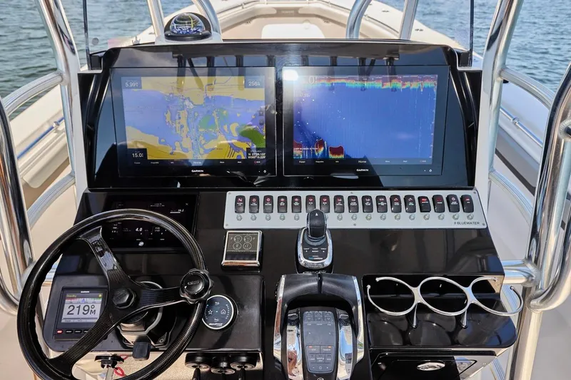 Slide: The Image of Control panel of 2022 Bluewater 35 boat with navigation screens and steering wheel. - 30