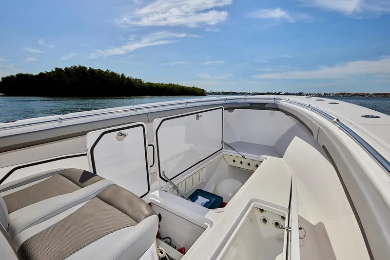 Slide: The Image of 2022 Bluewater 35 boat interior with open storage compartments, on a sunny day by the water. - 32