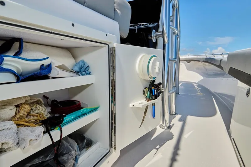 Slide: The Image of 2022 Bluewater 35 boat interior storage with shelves and equipment, under clear blue sky. - 33