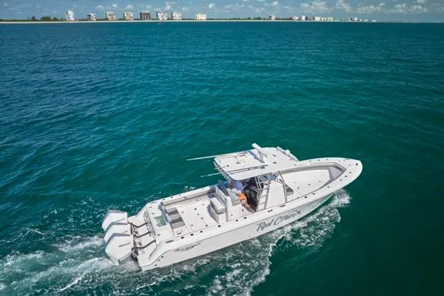 Slide: The Image of 2022 Bluewater 35 boat cruising on open ocean with distant shoreline. - 47