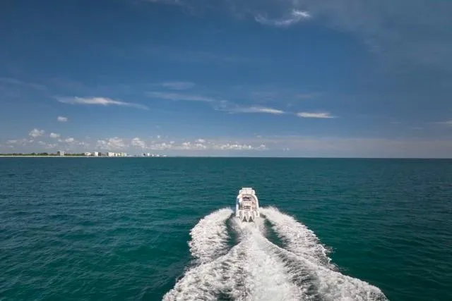 Slide: The Image of Bluewater 35 boat cruising on open sea, 2022 model, under clear blue sky. - 48