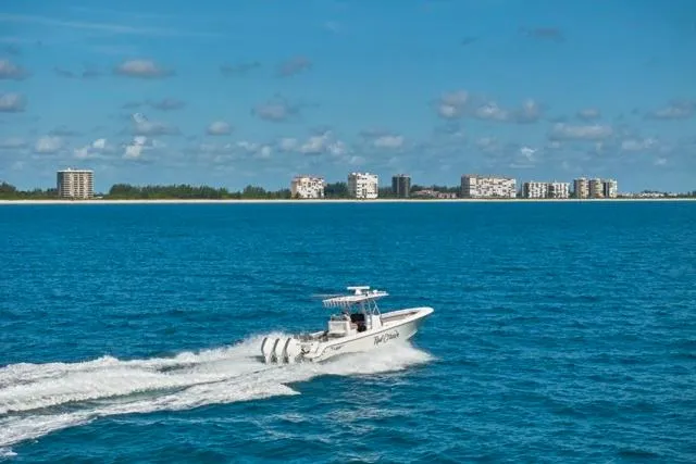 Slide: The Image of 2022 Bluewater 35 boat cruising on ocean with city skyline in background. - 53