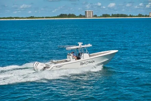 Slide: The Image of 2022 Bluewater 35 boat cruising on blue ocean near coastline under clear sky. - 56