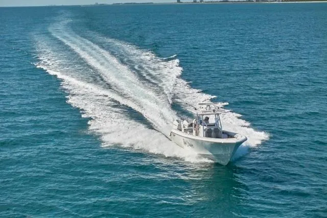 Slide: The Image of Bluewater 35 boat cruising on open sea, 2022 model, leaving a wake behind. - 62