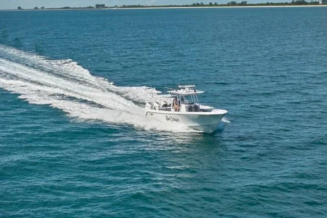 Slide: The Image of 2022 Bluewater 35 boat cruising on open water, leaving a wake behind. - 63
