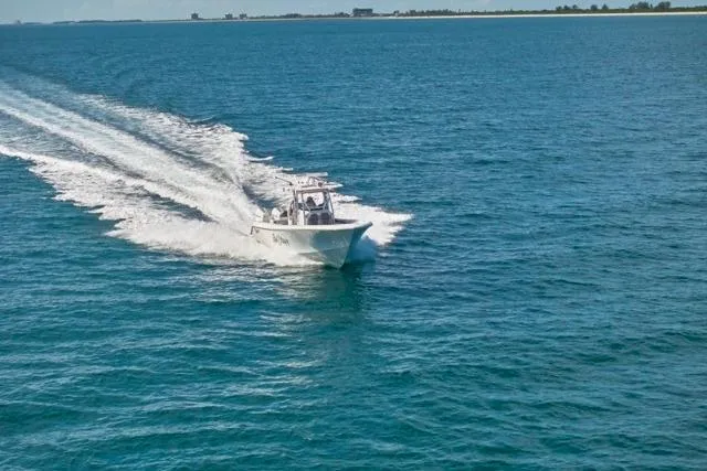 Slide: The Image of Bluewater 35 boat cruising on open sea, 2022 model, leaving a wake behind. - 64