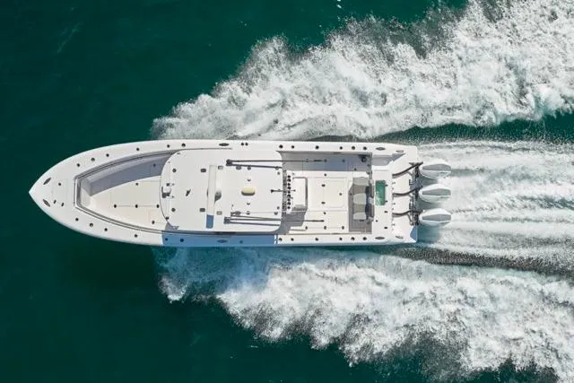 Slide: The Image of Aerial view of 2022 Bluewater 35 boat cruising on turquoise water. - 66
