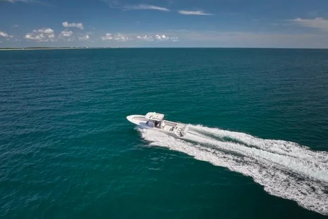 Slide: The Image of Bluewater 35 boat cruising on open ocean, 2022 model, under clear blue sky. - 67