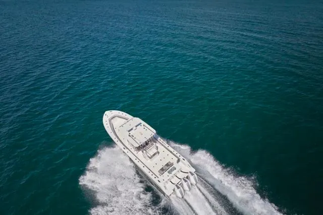 Slide: The Image of Aerial view of 2022 Bluewater 35 boat cruising on open ocean waters. - 68