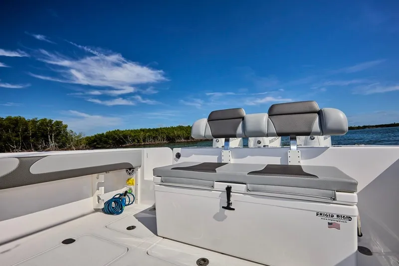 Slide: The Image of 2022 Bluewater 35 boat interior with seating, under a clear blue sky. - 7