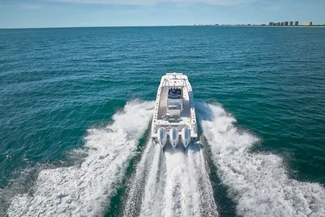 Slide: The Image of Bluewater 35 boat cruising on open sea, 2022 model, rear view. - 73