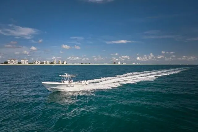 Slide: The Image of 2022 Bluewater 35 boat cruising on open sea under clear blue sky. - 76