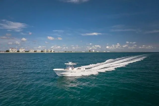 Slide: The Image of 2022 Bluewater 35 boat cruising on open ocean under clear blue sky. - 77