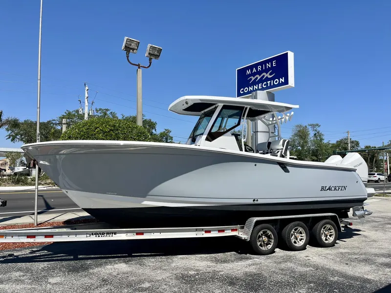 Slide: The Image of 2023 Blackfin 272 boat on trailer at Marine Connection dealership. - 1